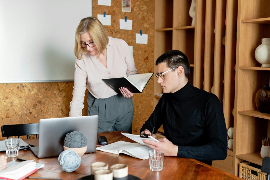 Image of a man and woman at the table for the blog Stop Protecting the Golden Egg—Start Preparing Your Successor