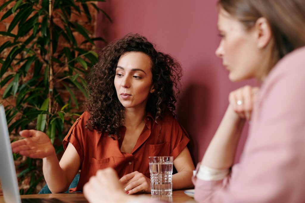 Image of two women looking at something for the blog The Succession Crisis No One's Talking About: Why Next Gens Are Walking Away