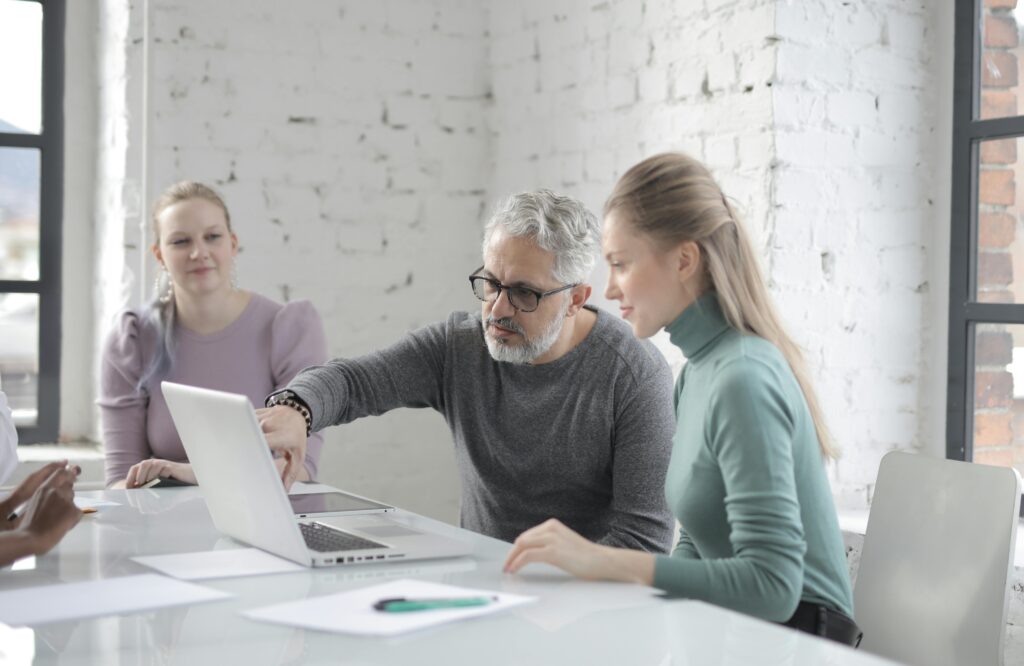 Image of people in a meeting discussing for the blog When Fear Keeps Your Family Business Stuck
