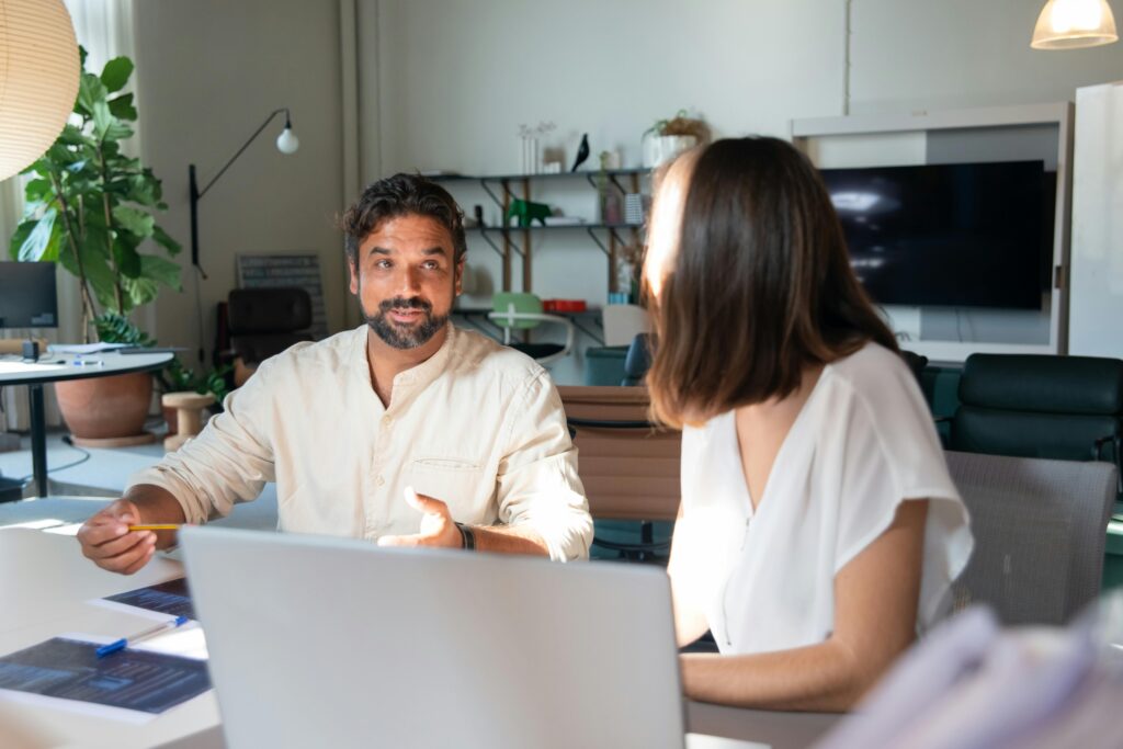 Image of man and woman talking for the blog, Building Her Own Name: Brecken Glenn on Identity Legacy and Leadership in a Family Business.