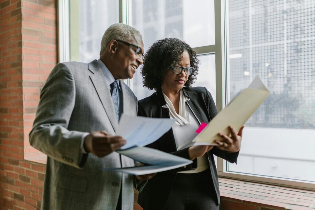 IMage of a man and woman looking at a docment for the blog, Business Transition Roadmap for Private Company Owners