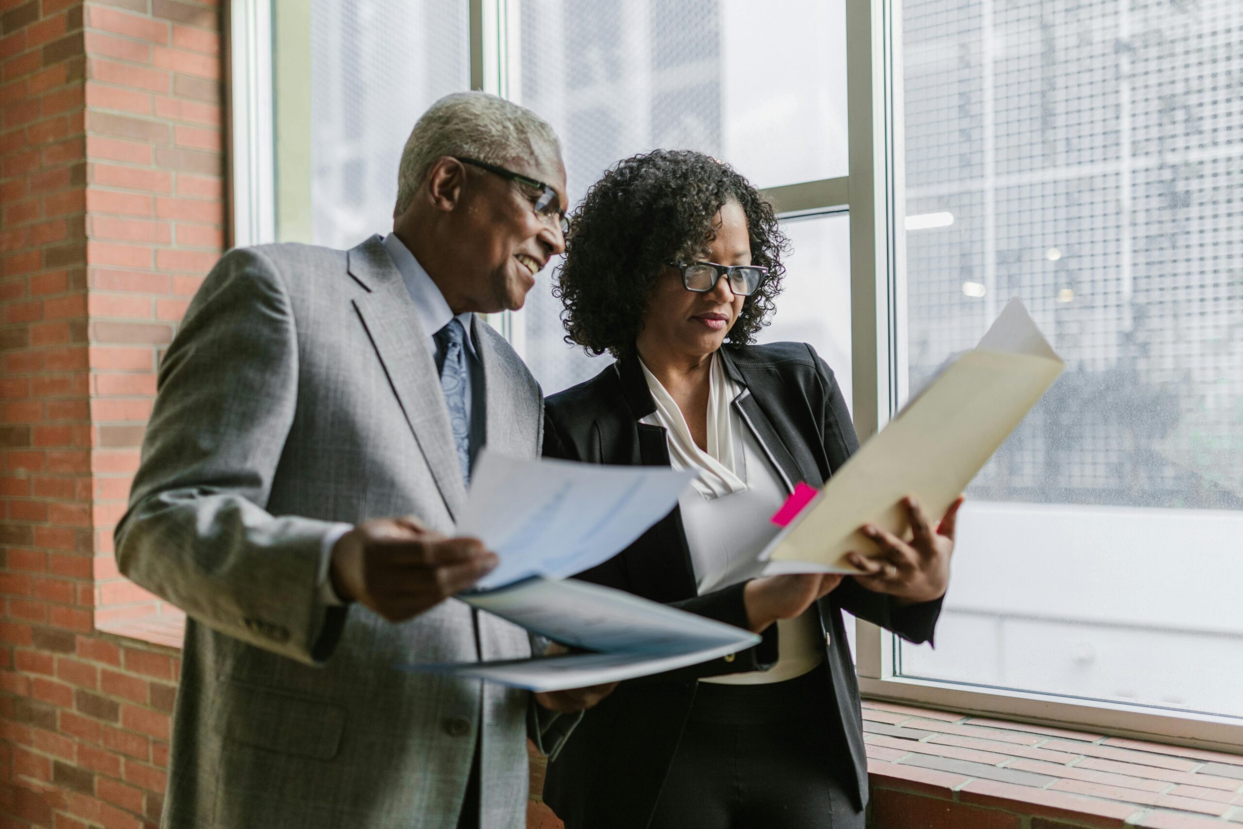 IMage of a man and woman looking at a docment for the blog, Business Transition Roadmap for Private Company Owners