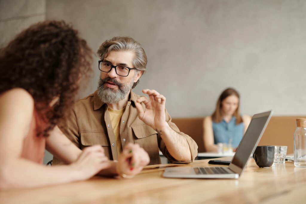 A man and a woman discussing something for the blog: Old Patterns, New Roles: Why Family Business Conflict Rarely Starts in the Boardroom