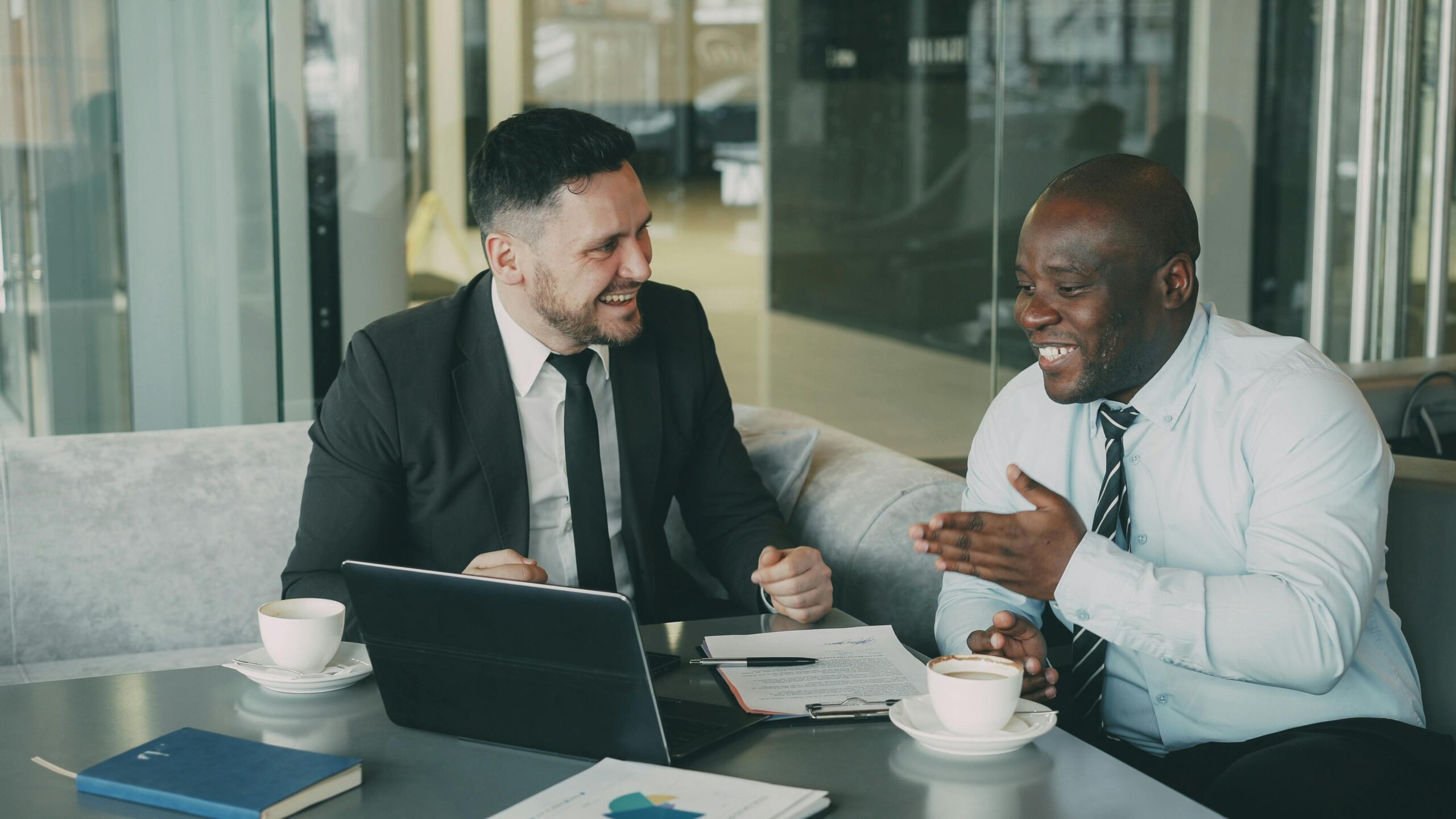 Image two men having a conversation for the blog, Sprinkle Kindness and Play the Long Game: What One Founder's Three-Transition Journey Can Teach Us All