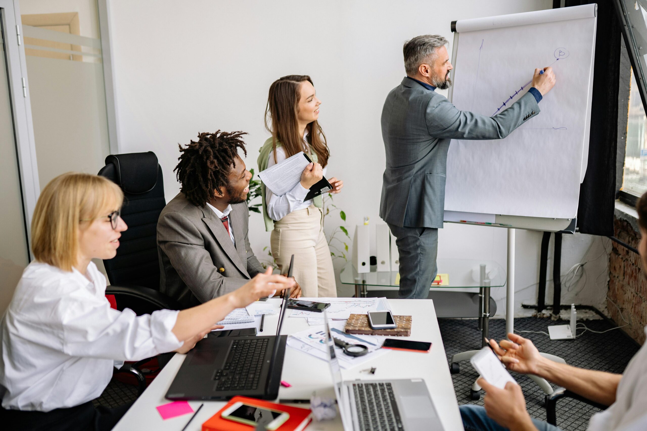 People in a meeting for the blog, Still Building? Good. Now Build the One Thing You’re Missing.