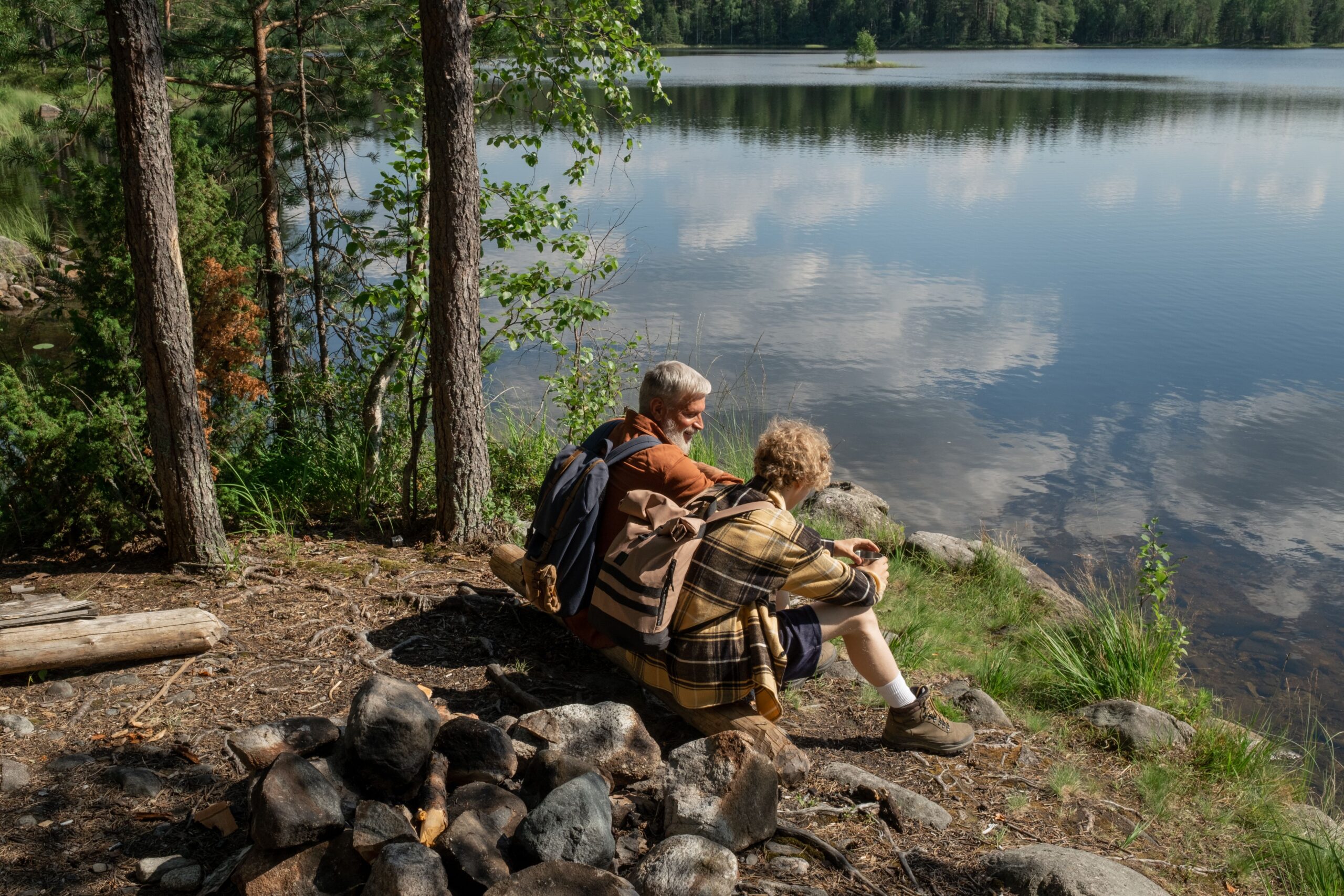 Image of an old man and woman sitting by a body of water for the blog, Business Transition Strategy for Founders Looking for “What’s Next”