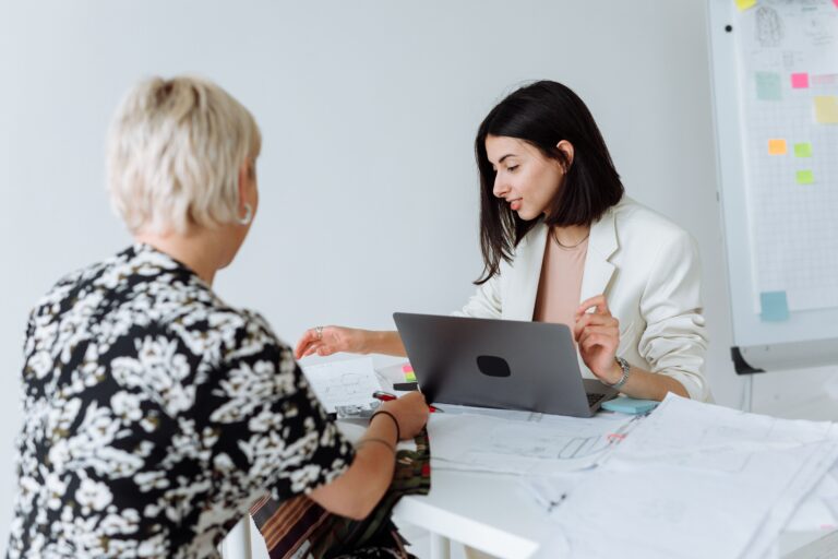 Image of an old woman and a young woman for the blog, How to Step Back From Your Business Without Selling It